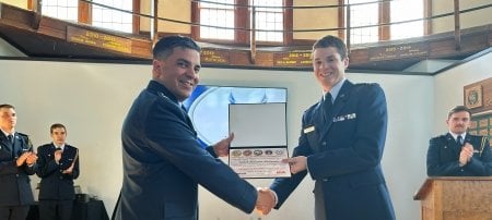 McKenzie receives the unmanned systems award from his commander, Lt. Col. Ben Zuniga, in the ROTC building at Michigan Tech.