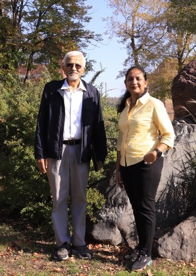 A Fulbright scholar and her academic sponsor stand in the rock garden at Michigan Tech outside the physics department where they conduct their teaching and research.