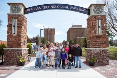 Trewhella family poses under arch