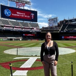 Elise Buzzell standing on the Minnesota Twins baseball field.