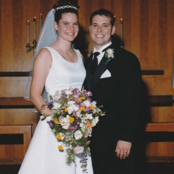 Wedding photo of Dannett and Jerry in a church with her holding a bouquet.