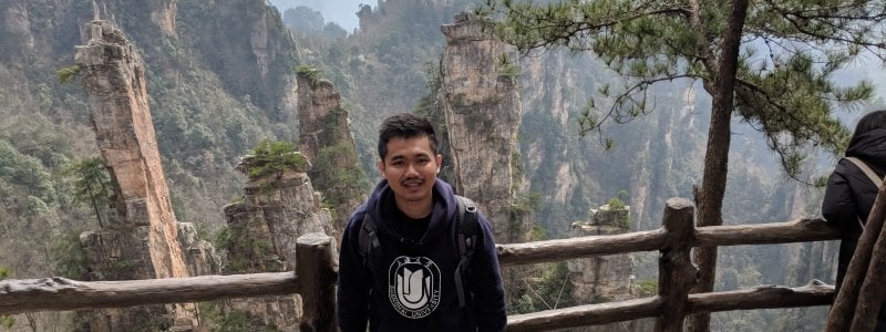 Student in front of mountains in China