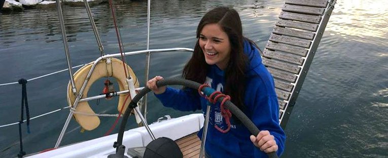 Student steering a boat.