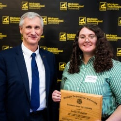 2025 President's Award awardee, Isobel, poses with President Koubek