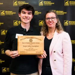 Dean of Students Award for Service Awardee, Jasper, poses with Kellie, the Dean of Students