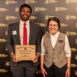 Provost's Award recipient Christian Johnson smiles with Associate Provost for Undergraduate Education, Dr. Jean Kampe.
