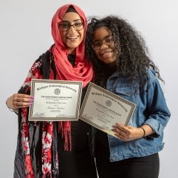 Fatima and Andrea pose with their nomination certificates.