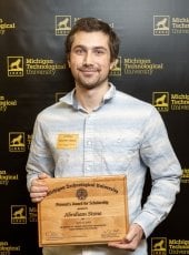 Abraham Stone poses with the Provost's Award