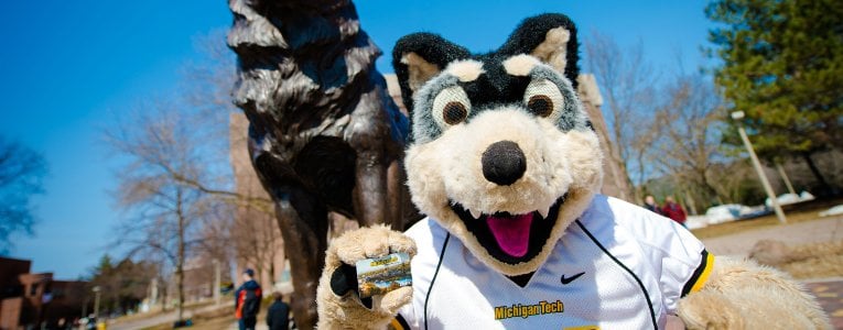 Blizzard T. Husky in front of the Husky Statue.