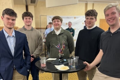 students pose with award
