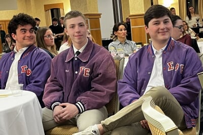 students sit while listening to a speaker