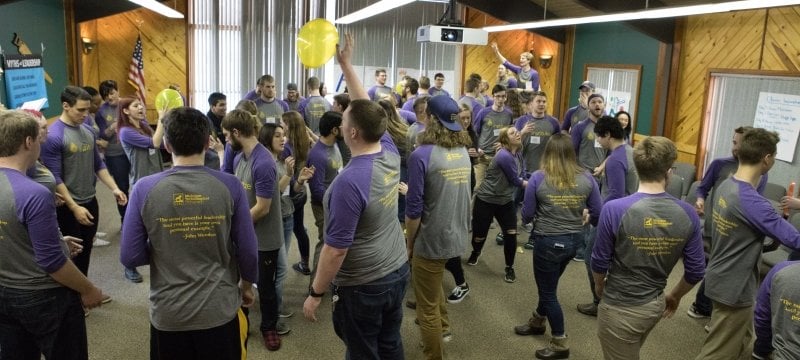 2018 participants batting a balloon around the room.