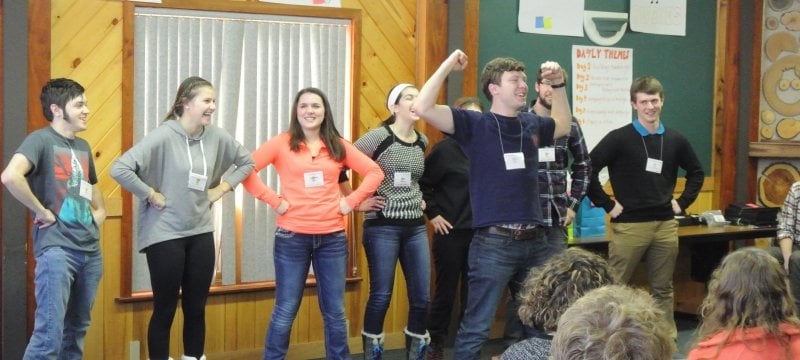 2015 participants in front of an audience with hands on hips.