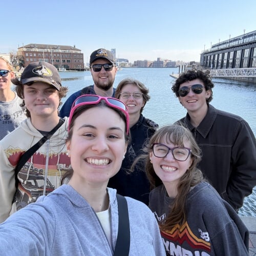 group poses infront of a ocean backdrop