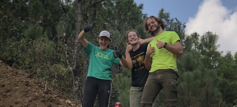 Three students giving thumbs up.