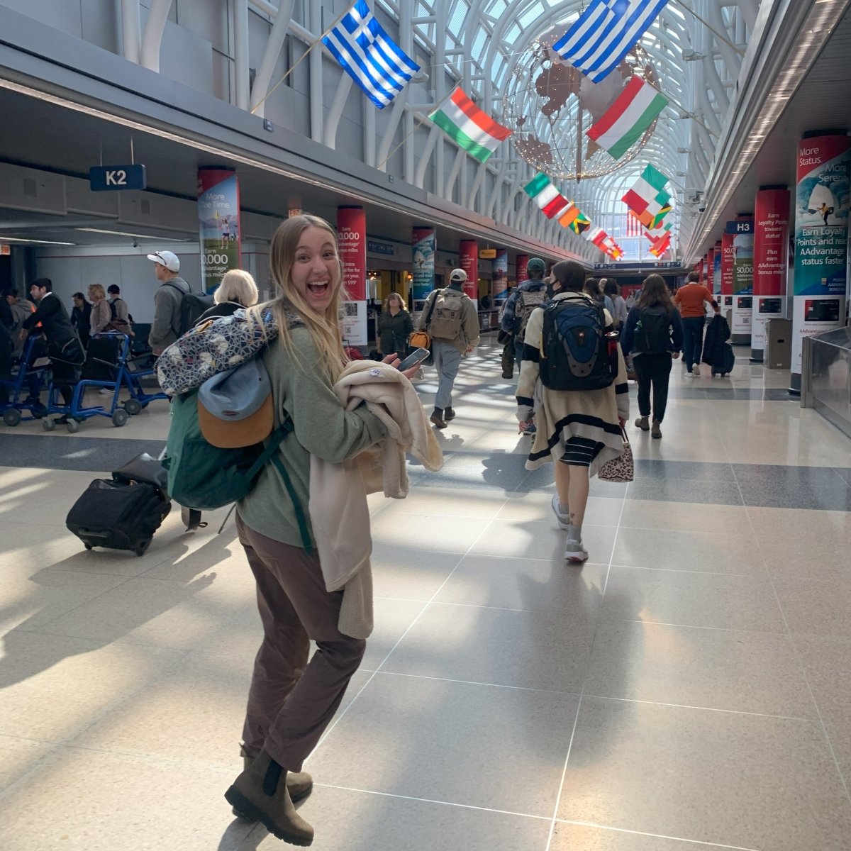 Liv, a participant on the Ecuador trip, smiles in excitement at O'Hare Airport
