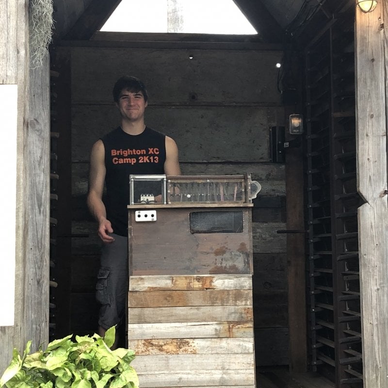 Aaron standing in a shed.