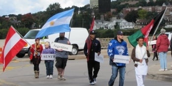 Students from several countries carrying their flags in the parade.