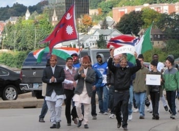Students from a few countries carrying their flags in the parade.