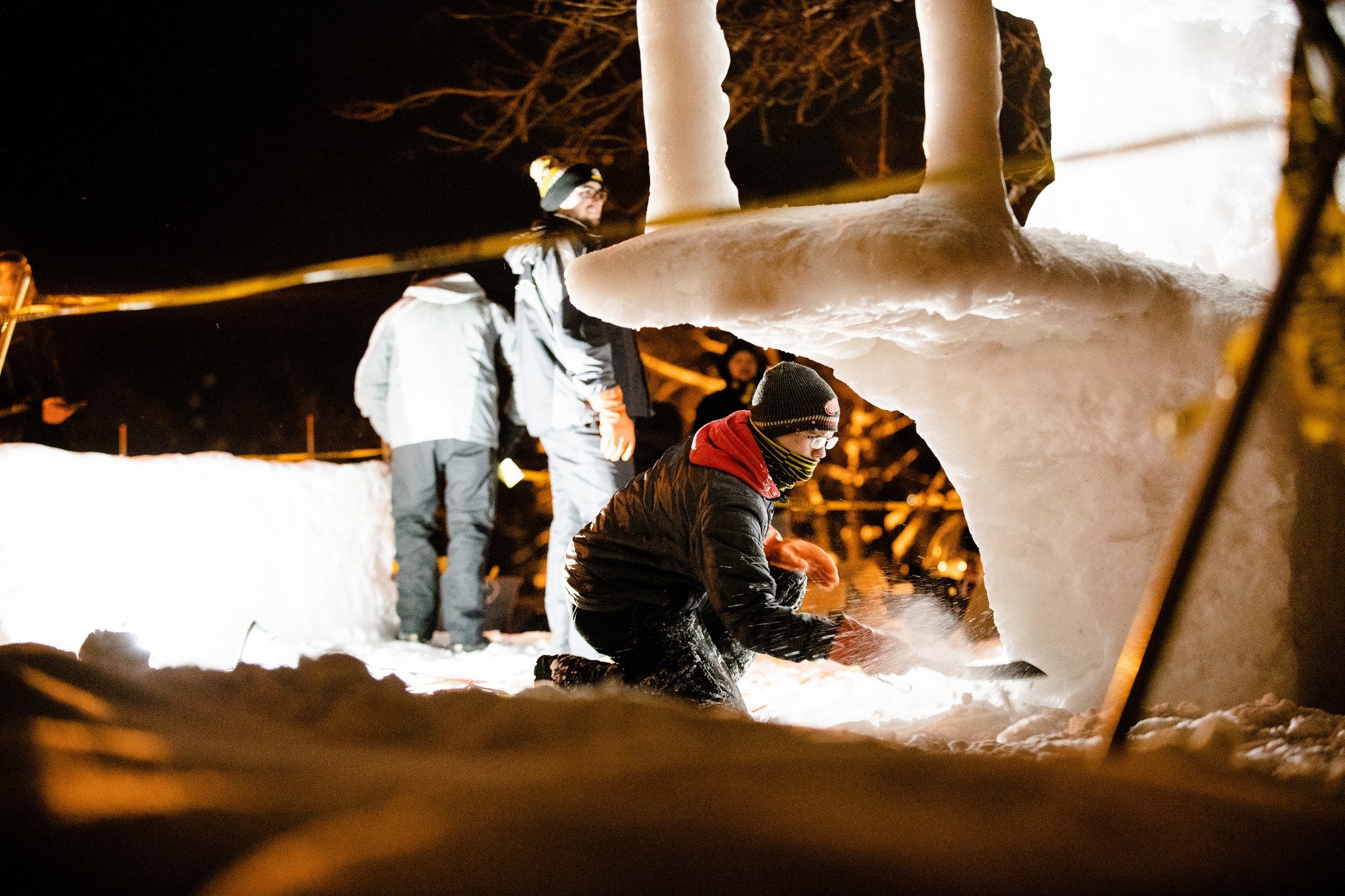 Student shaping a snow statue