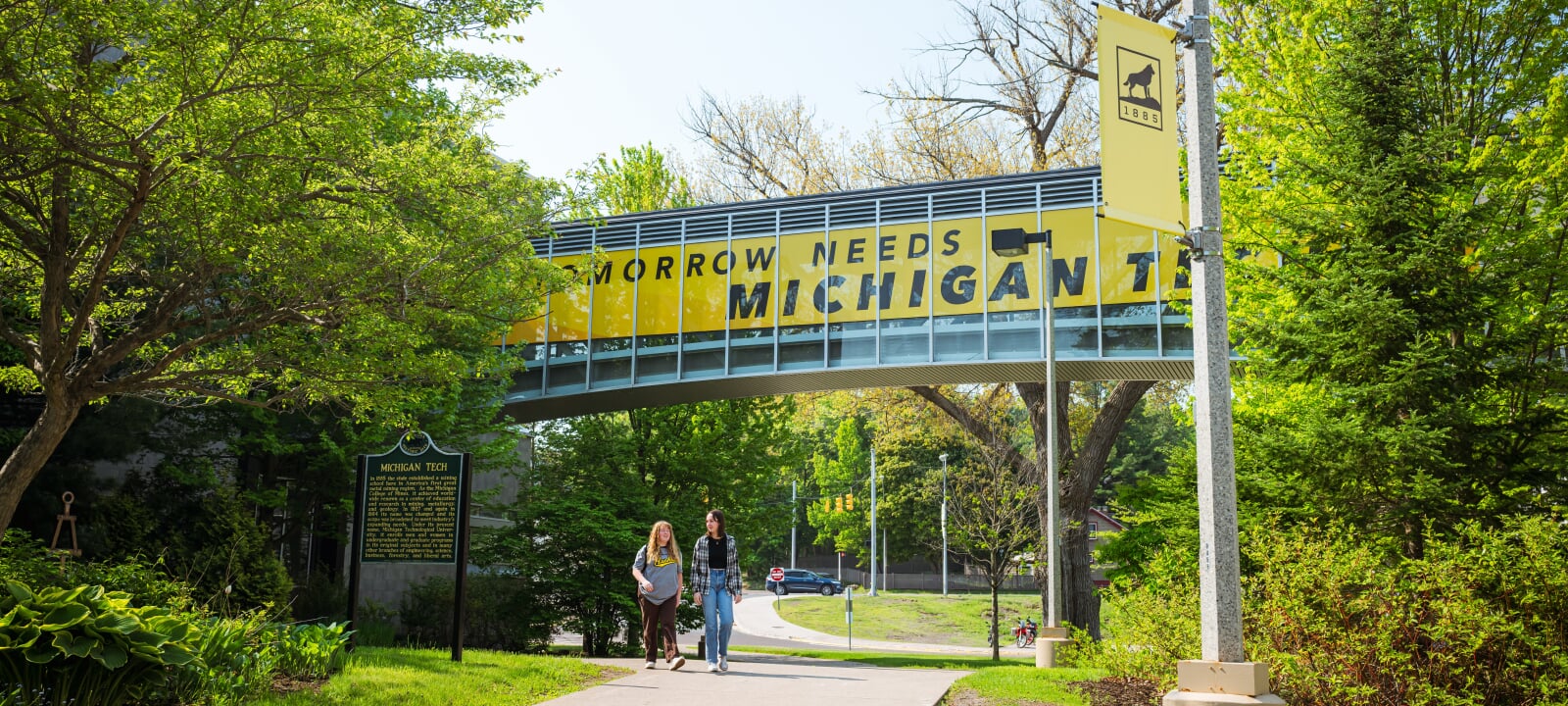 Students walking under the Michigan Tech walkway