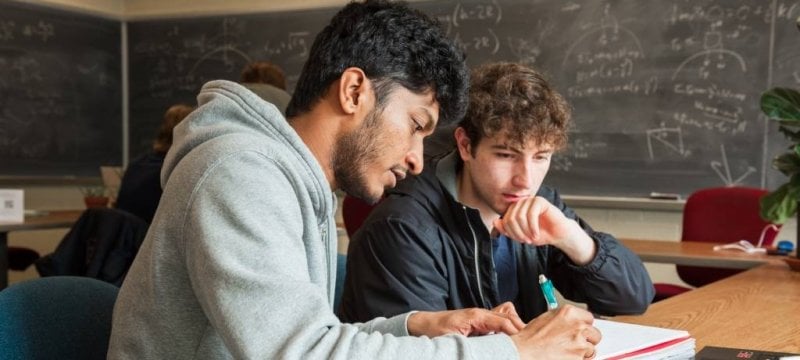 A learning center coach at work with a student