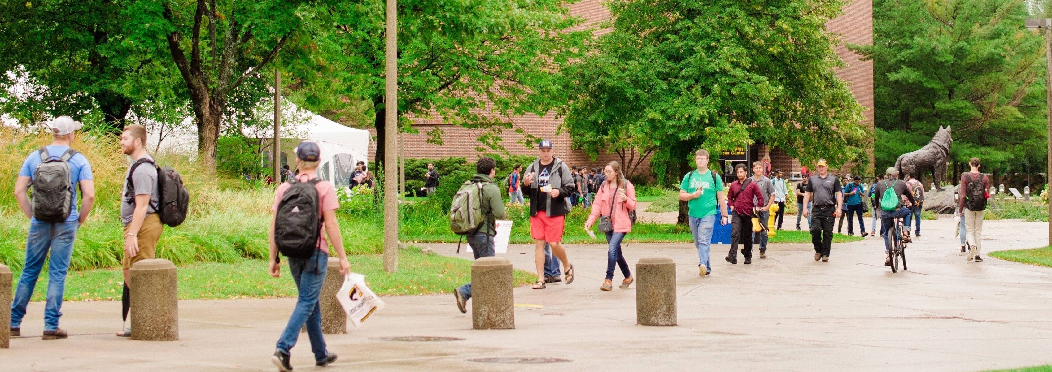 students walking and biking across campus on the first day of classes