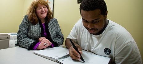 staff member working with a student