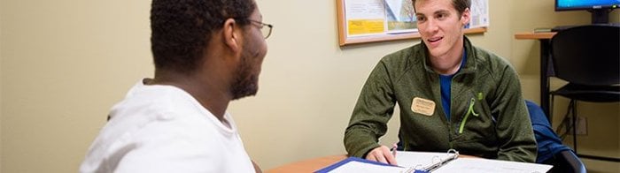 student talking with a staff member