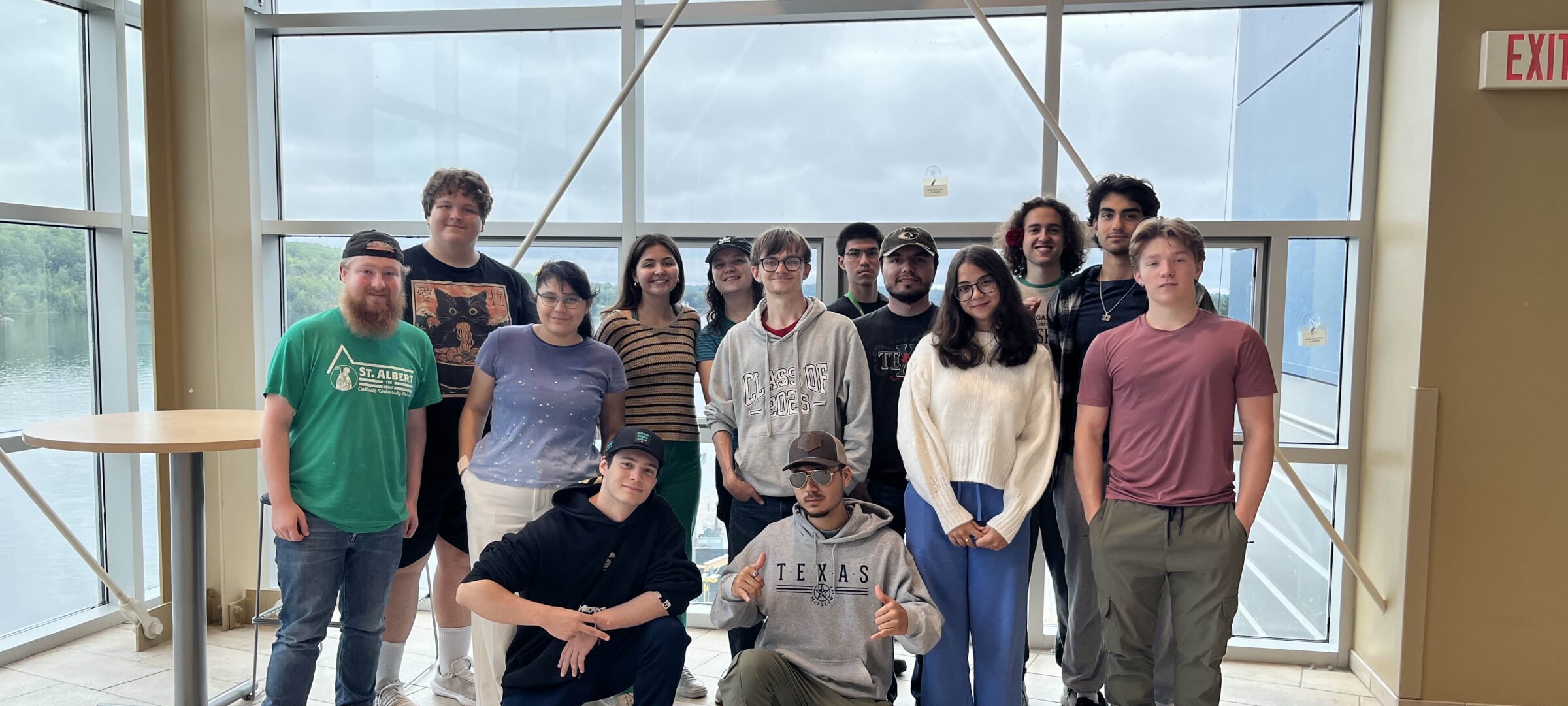 A diverse group of students smiling for a group photo.