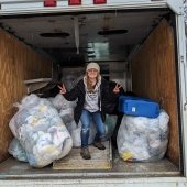 Student worker, Arika, collects recycling on campus