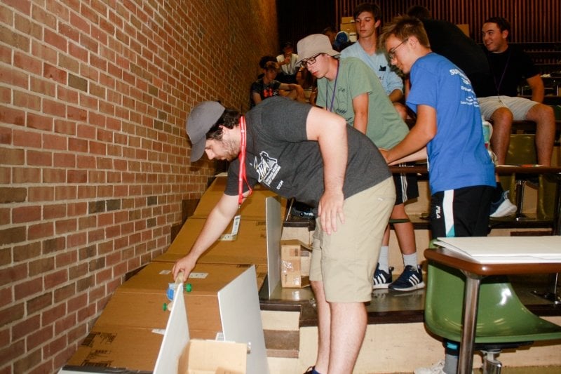 Automotive engineering lab on the stairs with cardboard and cars