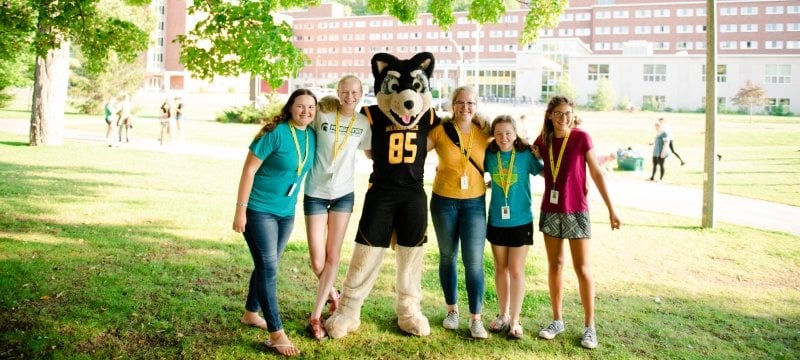 New friends from SYP pose with Blizzard, the Michigan Tech mascot.