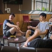 Two young men playing cards