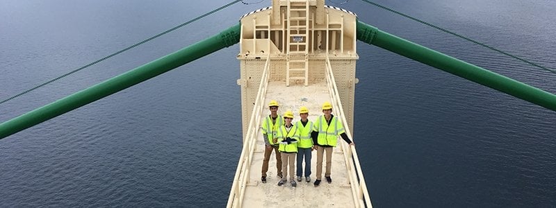 SYP students in safety vests stand on top of the Mackinac Bridge