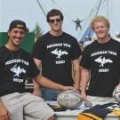 Three members of the Rugby club pose for a photo at K-Day.