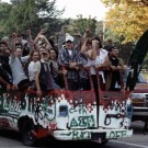 Homecoming Parade [A van loaded with happy students is shown.]