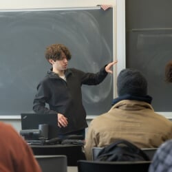 Student in front of a classroom