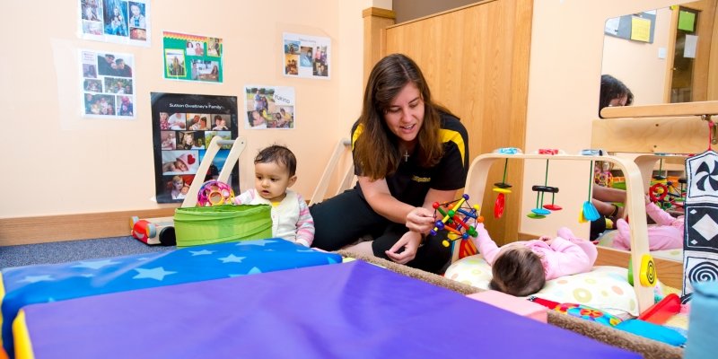 Teacher with two infants.