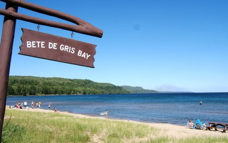 Beach and water with Bete De Gris Bay sign.
