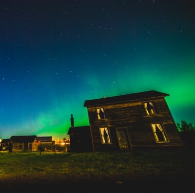 Aurora Borealis in the sky over the historic Quincy miner's house.