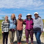 Researchers pose for photo at Sand Point