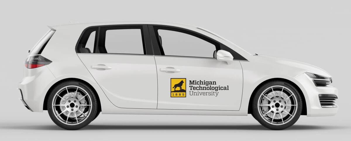 White car with two-color Michigan Technological University logo on the passenger door.