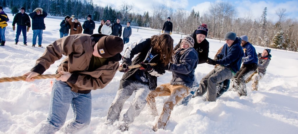 Students playing tug of war in the snow.