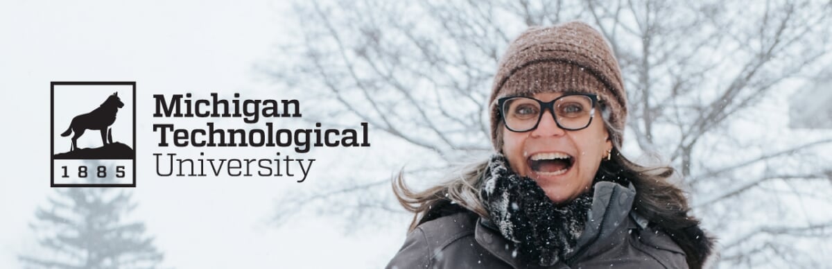 Black logo on a light area of a smiling person in the snow.