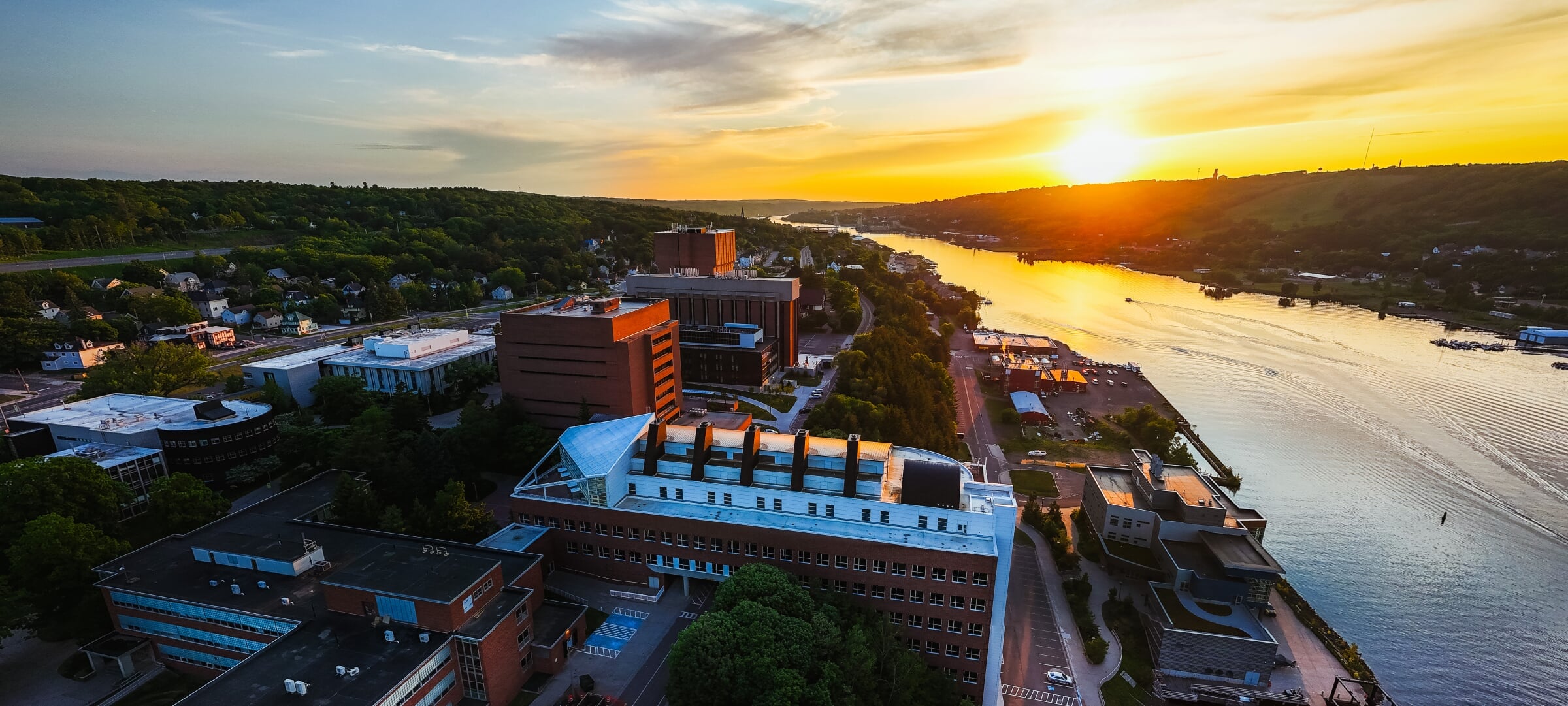 A sunset drone view of campus and the Portage Canal waterway.