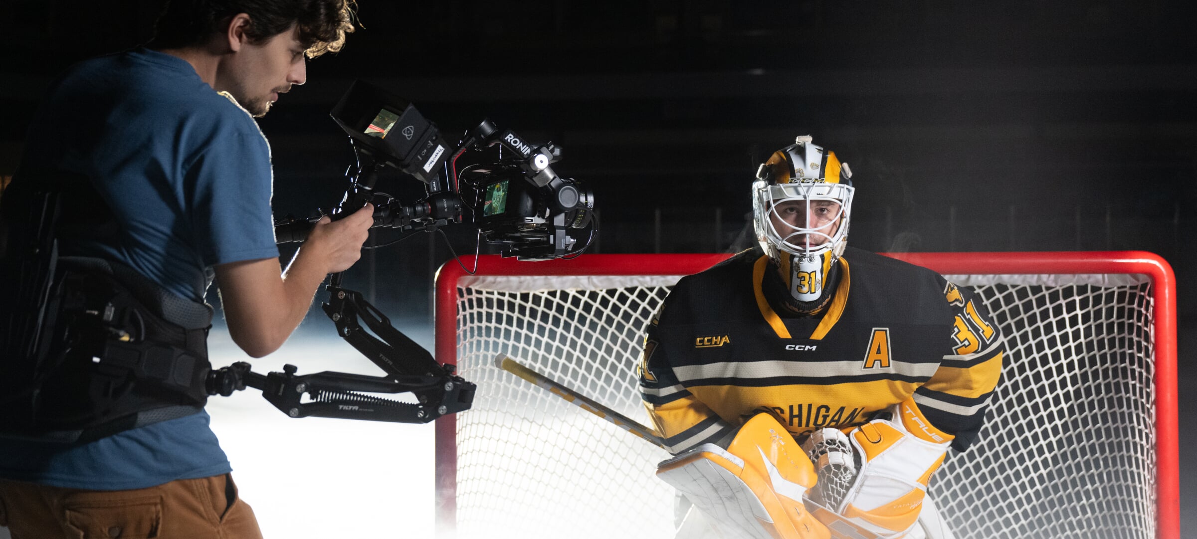 Videographer filming the Michigan Tech hockey goalie.
