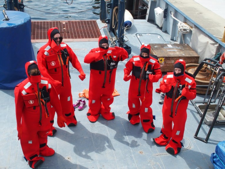 UNOLS crew putting on Gumby Suits