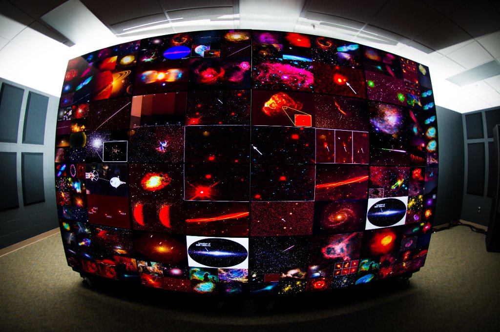 The display screens in a computer science lab light up with images of space.