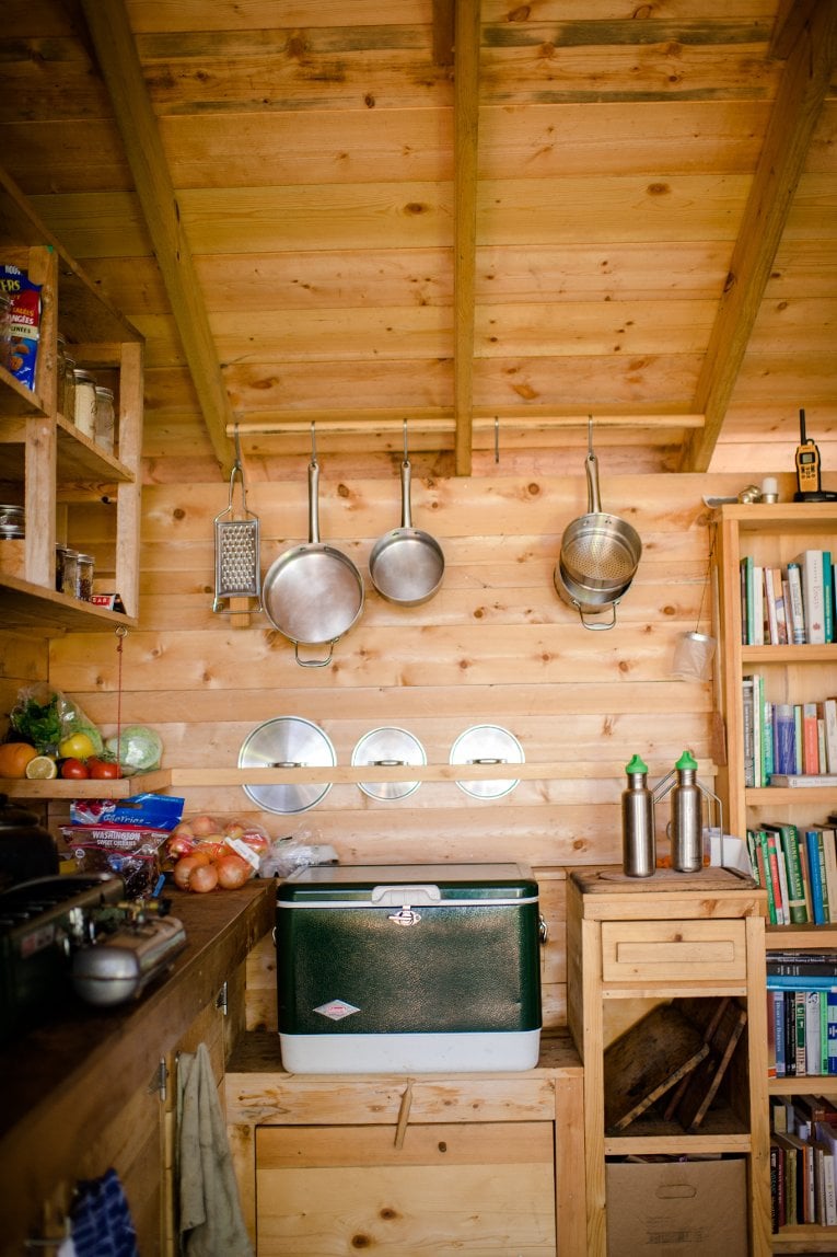 Rabbit Island kitchen Fresh produce, cooler, a lending library of eclectic selections stocked by readers in residence over the years... "even what's on the shelves is fascinating," says geotourist Robin Hammer Mueller.